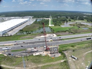 Image of crane installing posts for wildlife crossing across Interstate 4.