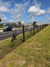 New fencing in the median helps guide pedestrians to signalized intersections with crosswalks for added safety. The fence is decorated with the City of Lakeland Swans.