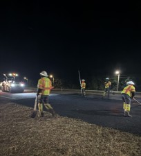 Workers Smooth Asphalt Before the Roller Compacts it on 01-21-26